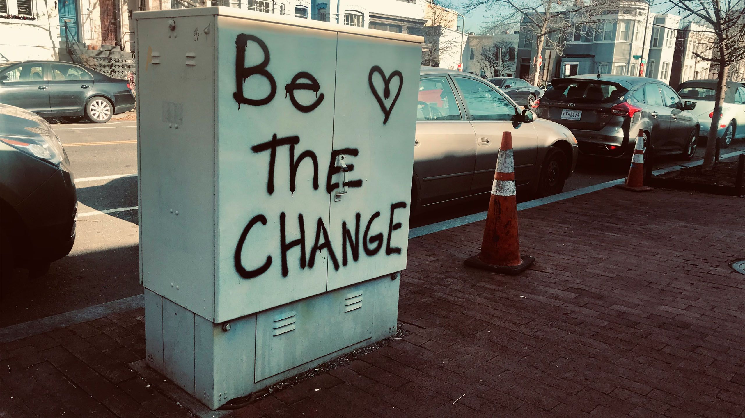 Be the Change spraypainted in a city