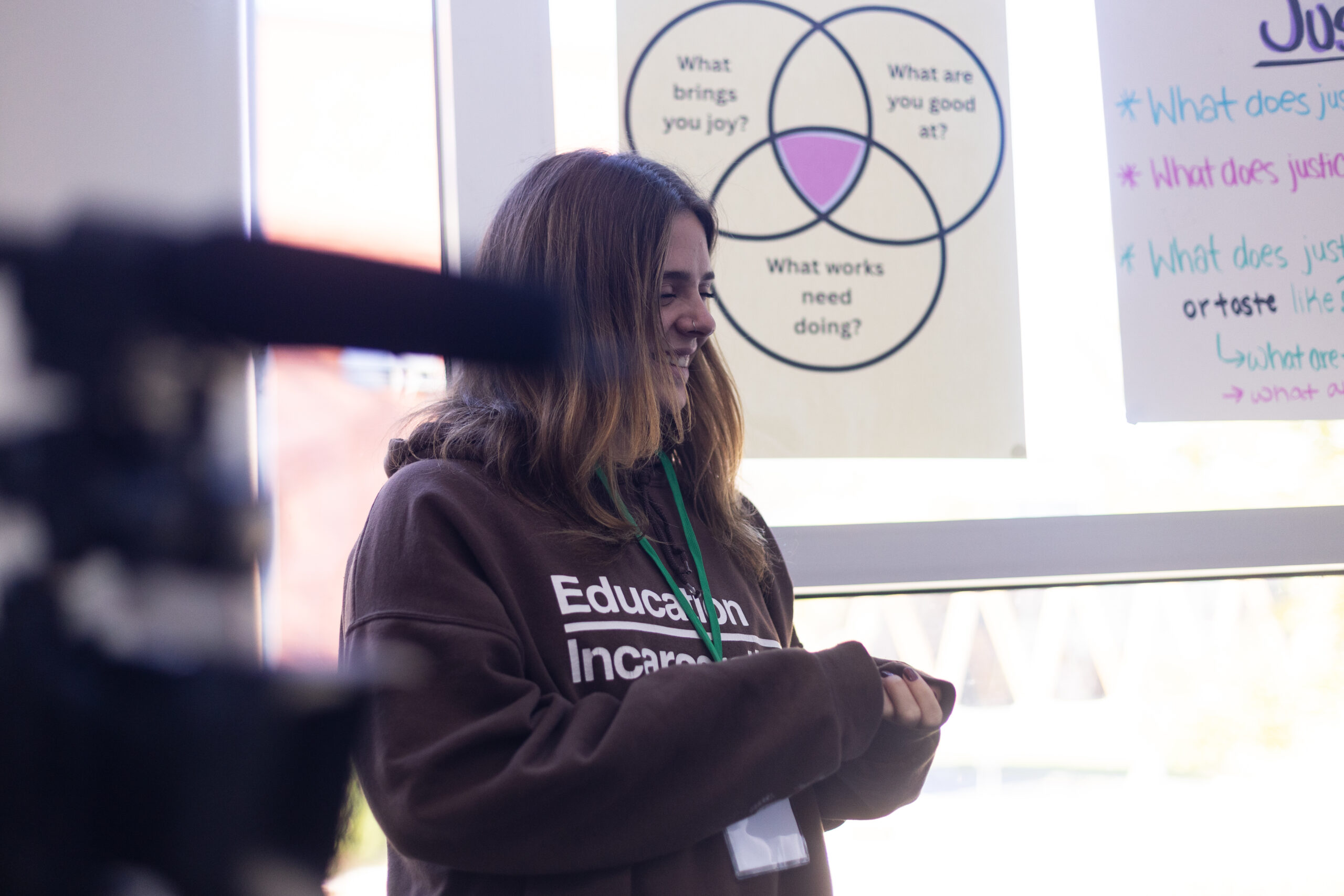 A trio of young people laugh outside